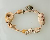 String of beads; 4400–3800 BC; the beads are made of bone, serpentinite and shell; length: 15 cm; Metropolitan Museum of Art