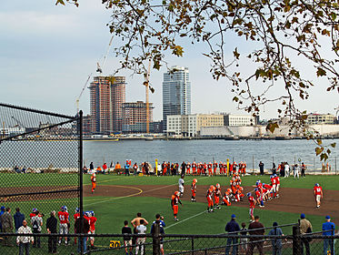 The East River passes children playing football in East River Park (2008)