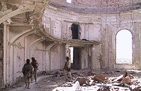 2002: US commandos patrolling a heavily bombed out room