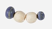 String of beads; 3650–3100 BC; lapis lazuli (the blue beads) and travertine (the white beads) (Egyptian alabaster); length: 4.5 centimetres (1.8 in); by Naqada II or Naqada III cultures; Metropolitan Museum of Art (New York City)