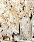 A monochrome relief stele depicting two figures dressed as Roman legionaries