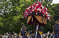 Man carrying a hollyhock float during the Aoi Matsuri procession