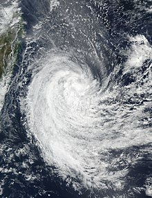 Satellite image of Cyclone Berguitta passing near Réunion as a weakened system. The cyclone's centre is just offshore the southeast coast of Réunion.