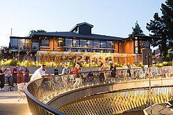 A picture of the outside of the New Wolsey Theatre during an outdoor event, with people gathered to watch a performance.
