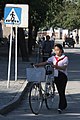 Young woman with bicycle, Kaesong, 2010