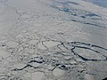 Aerial view showing an expanse of drift ice offshore Labrador (Eastern Canada) displaying floes of various sizes loosely packed, with open water in several networks of leads. (Scale not available.)