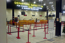 A row of desks beneath a large sign reading "For flights using U.S. customs and border protection".