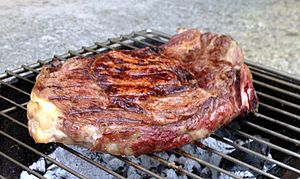 A rib steak, grilled on a barbecue
