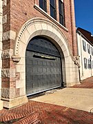 Renovations had replaced the garage's east door with a new door by December 2018.