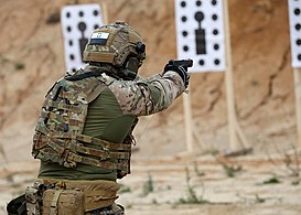 GROM operator conducting a pistol training exercise
