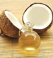 alt = A cracked coconut and a bottle of coconut oil