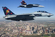 An F-14B and F/A-18F (assembled in the St. Louis area) fly over the city, 2005