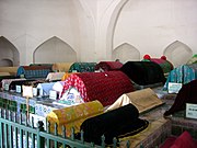 Tombs are decorated with blue glazed tiles and draped in colorful silks.