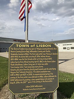 Historical sign outside the fire and highway departments detailing Lisbon village history