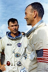 Young and Collins helmetless in spacesuits