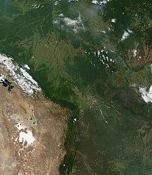A portion of the Andes mountains from space, showing the contrast between the dry terrain west of the mountain ridge and wet terrain to the east.