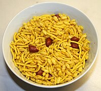 A bowl of sev mamra, consisting of puffed rice, peanuts and fried seasoned noodles