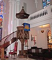 The "wine glass" pulpit and sounding board of 1872 survived the fire of 1965