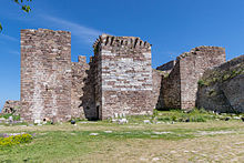 Photograph of a medieval fortification with three square towers