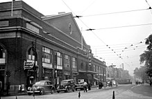 Black and white photo of arena exterior and street scene, circa 1945