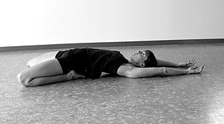 Saddle pose, the Yin version of Supta Virasana: this pose stretches the feet, knees, thighs, and arches the lumbar and sacral vertebrae. It is said to stimulate the Kidney meridian as well as the kidneys.[36][37]
