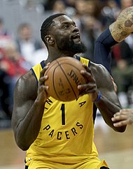 Stephenson holding a basketball and looking up