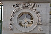 Louis XVI round window of the Petit Trianon (Versailles, France), with a festoon-derived ornament at the top