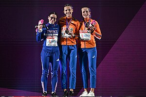 Photo of Louise Maraval, Femke Bol, and Cathelijn Peeters wearing track suits and holding their medals and stuffed mascottes at the European Athletics Championships in 2024