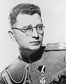 a black and white photograph of a man in uniform wearing glasses
