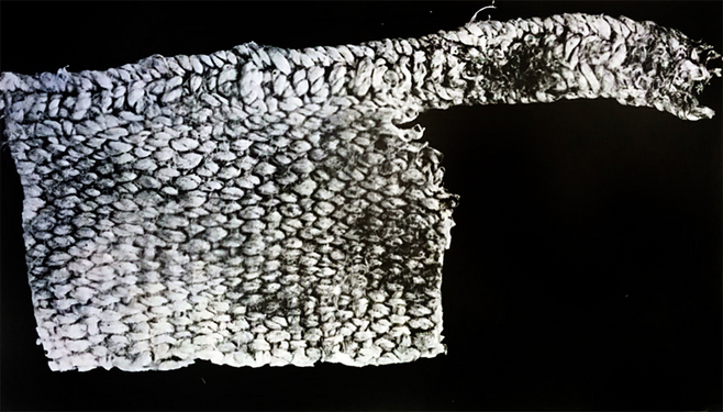 Igbo-ukwu 9th century textile associated with copper chain with weave pattern and selvedge.