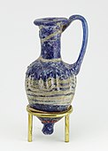 Ancient Egyptian perfume vase in shape of an amphoriskos; 664–630 BC; glass: 8 × 4 cm (3.1 × 1.5  in); Metropolitan Museum of Art (New York City)