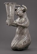 Kneeling Bull with Vessel. Kneeling bull holding a spouted vessel, Proto-Elamite period (3100–2900 BC). Metropolitan Museum of Art[6]