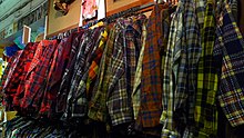 Clothing rack with very wide array of tartan flannel shirts