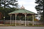 Flat site in Town Hall gardens; Has beautifully detailed cast-iron work; Has a green roof, white pil The fountain which was formerly in the centre was moved to the lower Town gardens some years ago. This ornamental Victorian cast-iron bandstand dates from 1912. It was donated to the Town Council by the engineers who were responsible for Kokstad's water Type of site: recreational Previous use: bandstand. Current use: pavilion. Historical and Architectural interest – This ornamental Victorian cast-iron bandstand dates from 191