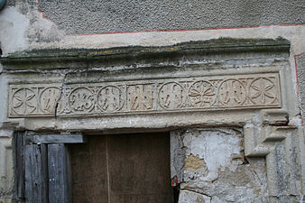 The delicately carved lintel of the same house. The picture also reveals the derelict state of this rare building (2006).