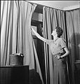 Adjusting blackout curtains in 1943