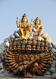 Statue of Ravana, with ten arms and heads, beneath Shiva and Parvati