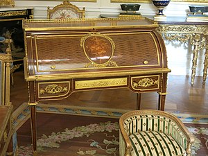 Roll-top desk of Marie-Antoinette; by Jean-Henri Riesener; 1784; oak and pine frame, sycamore, amaranth and rosewood veneer, bronze gilt; 103.6 x 113.4 cm; Louvre[69]