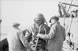 Royal Navy diver preparing to check the mooring lines of one of the gate ships