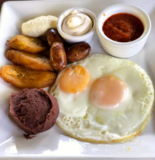 Typical Salvadoran breakfast: egg, beans, cream, plantain and chorizo