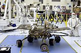 A rover being observed by several scientists.