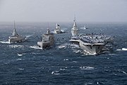 The French Navy as planned for the late 2030s: a Bâtiment ravitailleur de forces (fleet tanker) conducts simultaneous underway replenishment with the Future French aircraft carrier and with a Frégate de défense et d'intervention (Defence and Intervention Frigate).