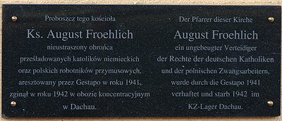 Bilingual commemorative plaque in memorial of Priester August Froehlich in front of St Paul's church in Drawsko Pomorskie.