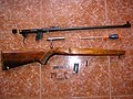 A Toz-17 rifle chambered for .22 long rifle which has been dissembled. The bolt is locked by the bolt handle being dropped into a notch in the receiver.