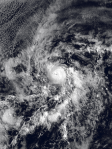A satellite image of a hurricane over the Eastern Pacific Ocean; there is a small core of dense white clouds with a tiny clearing near the center