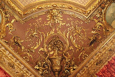 Second Empire style ceiling with a foliate head in the Napoleon III Apartments, in the Louvre Palace, Paris, designed by Hector Lefuel and decorated with paintings by Charles Raphaël Maréchal, 1859-1860[7]