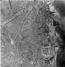 Photograph taken from high level looking down shows two bomber aircraft over port
