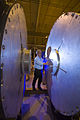 A technician examining one of the refurbished accelerator cells for DARHT's second-axis accelerator.