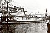 Black-and-white photo of long towboat on the water