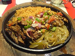 Tex-Mex: mixed beef and chicken fajita ingredients, served on a hot iron skillet